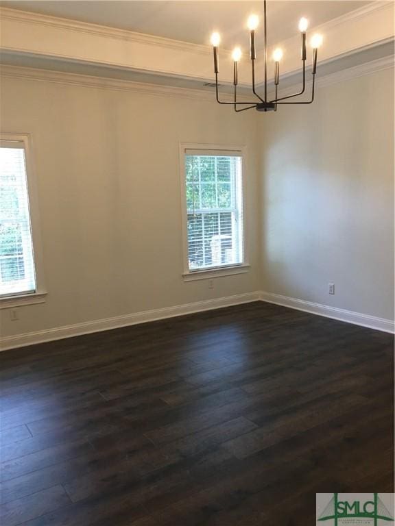 empty room with dark wood-type flooring, ornamental molding, baseboards, and a notable chandelier