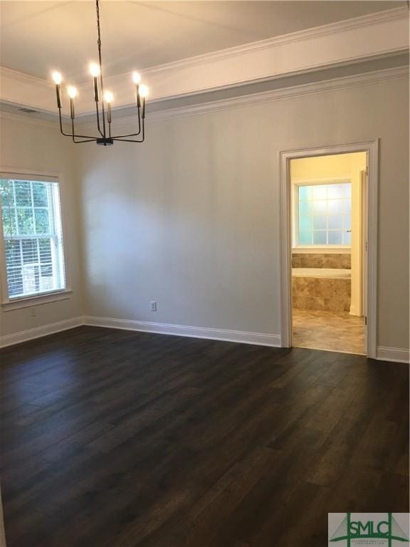 unfurnished dining area with dark wood-type flooring, ornamental molding, baseboards, and a notable chandelier