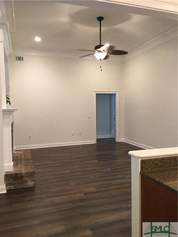 unfurnished living room with crown molding, ceiling fan, and dark hardwood / wood-style flooring