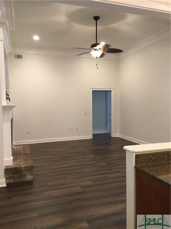 unfurnished living room with dark wood-type flooring, baseboards, visible vents, ceiling fan, and ornamental molding