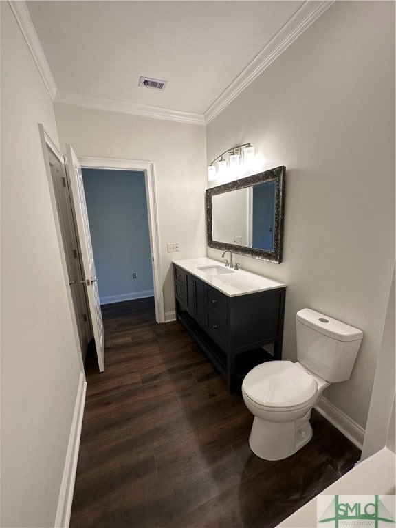 bathroom with ornamental molding, vanity, toilet, and hardwood / wood-style flooring