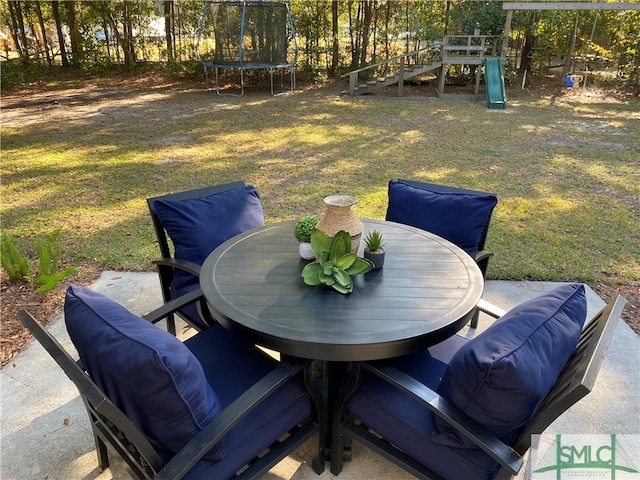 view of patio featuring a playground and a trampoline