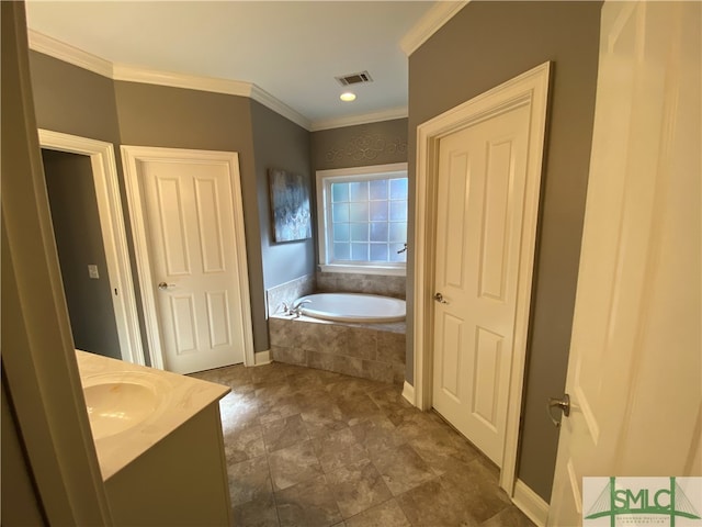 bathroom with tile patterned flooring, vanity, ornamental molding, and a relaxing tiled tub