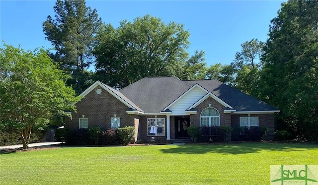 view of front of house with brick siding and a front yard