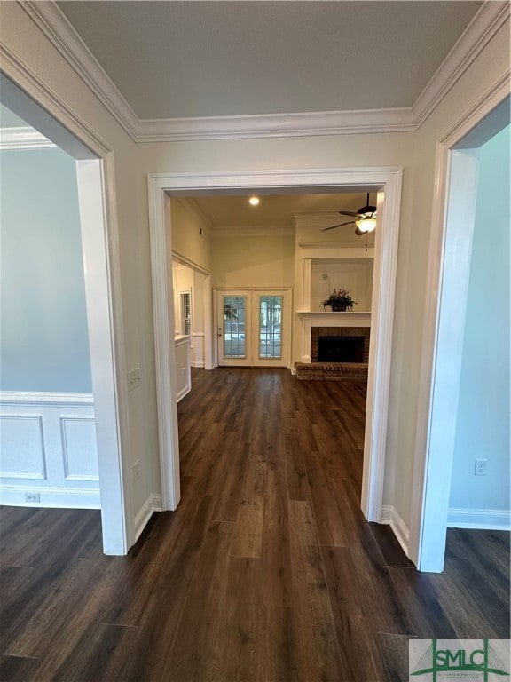 corridor featuring crown molding and dark wood-type flooring