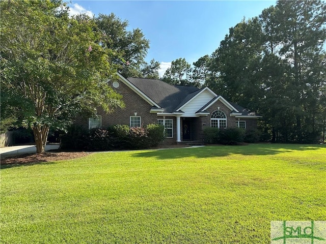 ranch-style home with brick siding and a front yard