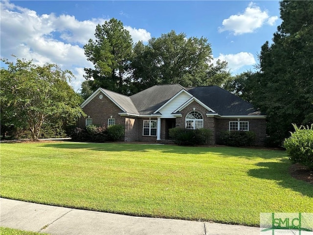 ranch-style house featuring a front yard and brick siding