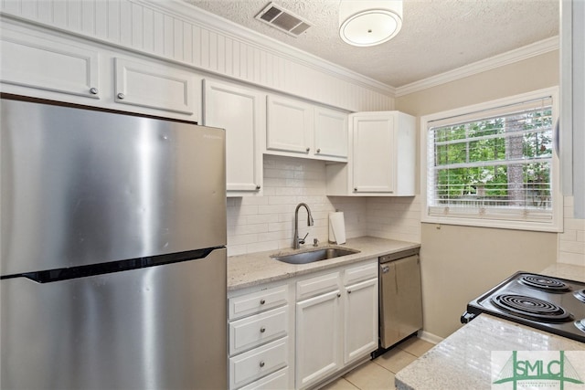 kitchen with white cabinets, appliances with stainless steel finishes, a textured ceiling, and sink