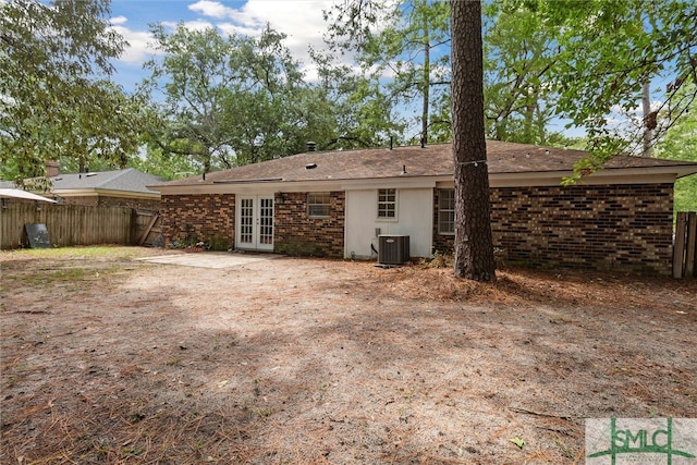 back of property with french doors and central AC