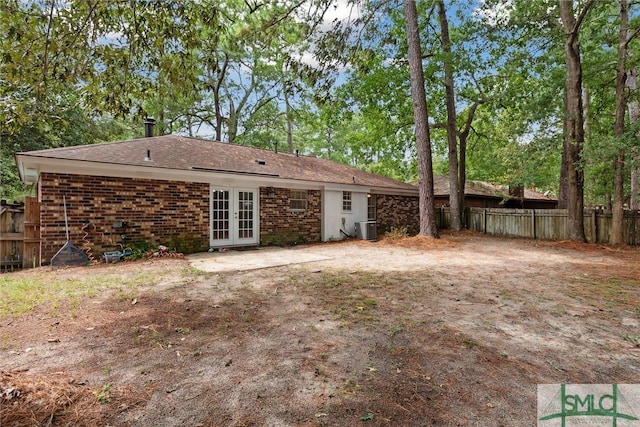 rear view of house with central AC and french doors