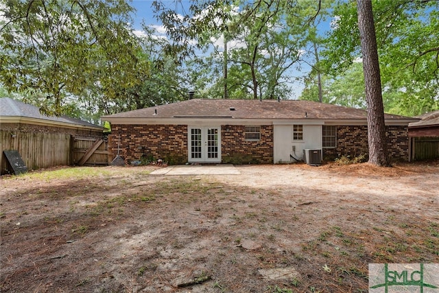 rear view of house with french doors and central AC