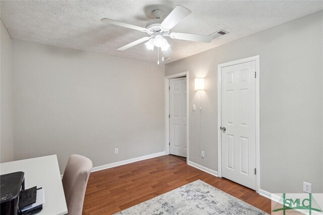 office area featuring a textured ceiling, ceiling fan, and hardwood / wood-style flooring