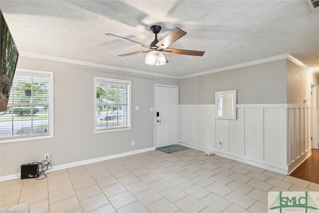 unfurnished room with ornamental molding, a textured ceiling, and ceiling fan