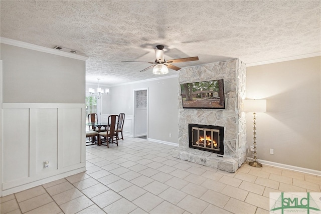 unfurnished living room featuring a fireplace, crown molding, ceiling fan with notable chandelier, a textured ceiling, and light tile patterned floors