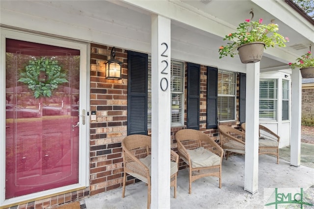 view of exterior entry featuring a porch