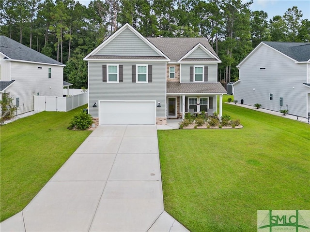 view of front of home featuring driveway, fence, a front yard, a shingled roof, and a garage