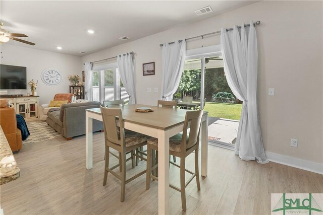 dining room with ceiling fan and light hardwood / wood-style floors