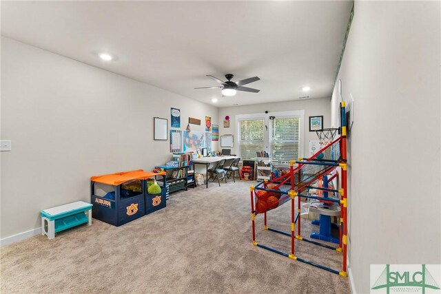 playroom with ceiling fan and carpet