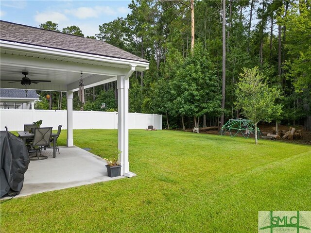 view of yard featuring ceiling fan and a patio