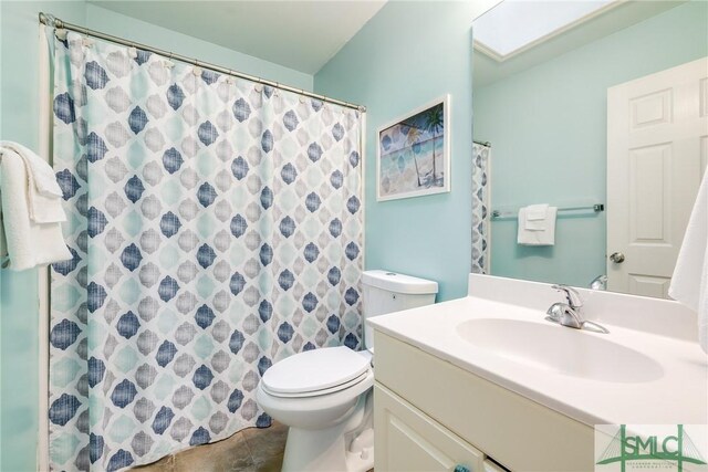 bathroom featuring vanity, toilet, a shower with curtain, and tile patterned floors