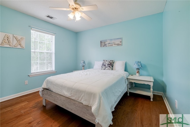 bedroom featuring dark hardwood / wood-style flooring and ceiling fan