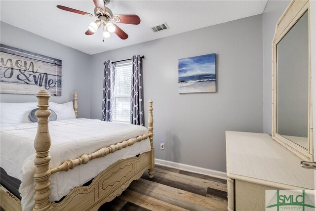 bedroom with dark wood-type flooring and ceiling fan