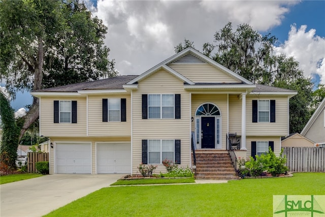 split foyer home with a front yard and a garage