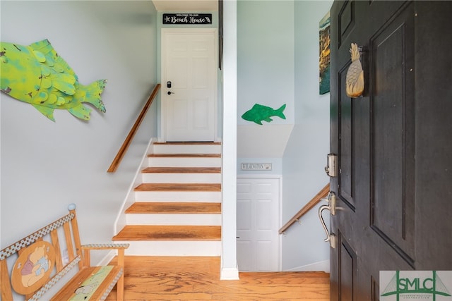 staircase featuring wood-type flooring