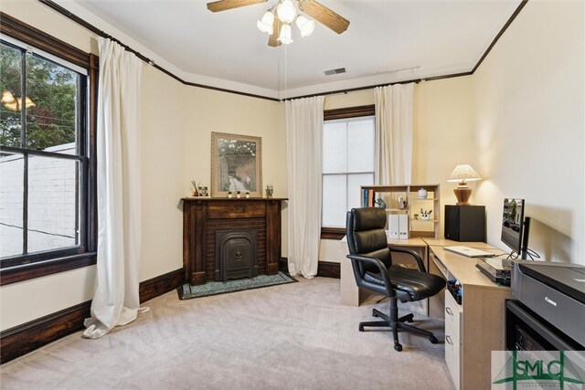 carpeted office space with ceiling fan and crown molding