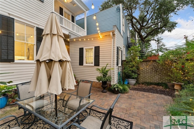 back of house featuring a balcony and a patio