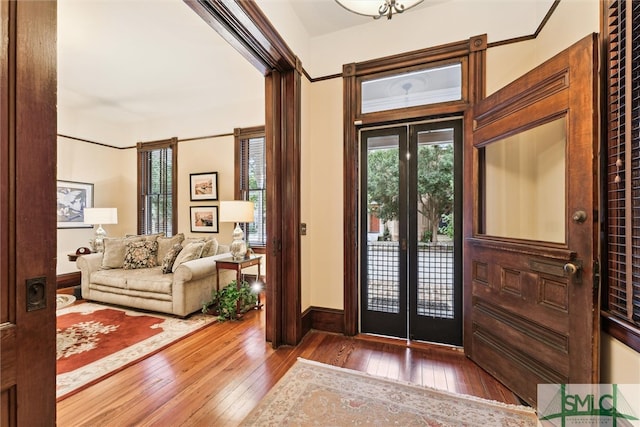 entrance foyer featuring crown molding, french doors, and dark hardwood / wood-style floors