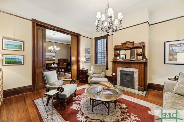 sitting room featuring hardwood / wood-style flooring, a chandelier, and ornamental molding