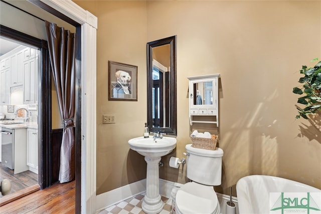 bathroom featuring toilet, sink, and hardwood / wood-style floors