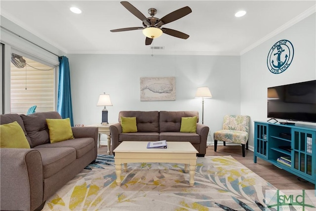 living room featuring recessed lighting, wood finished floors, visible vents, and crown molding