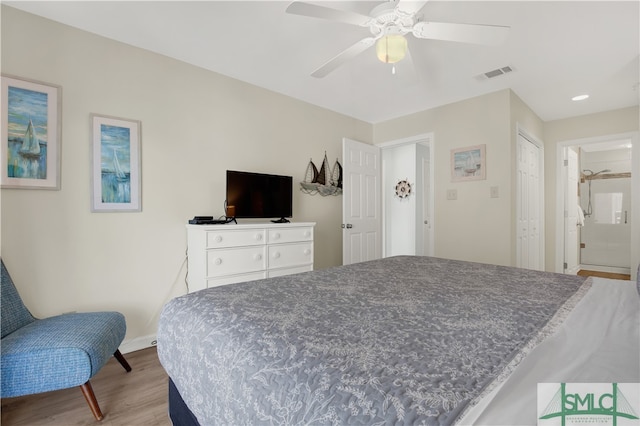 bedroom with light hardwood / wood-style flooring, ceiling fan, and a closet