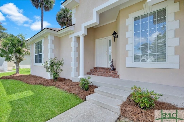 view of exterior entry with stucco siding