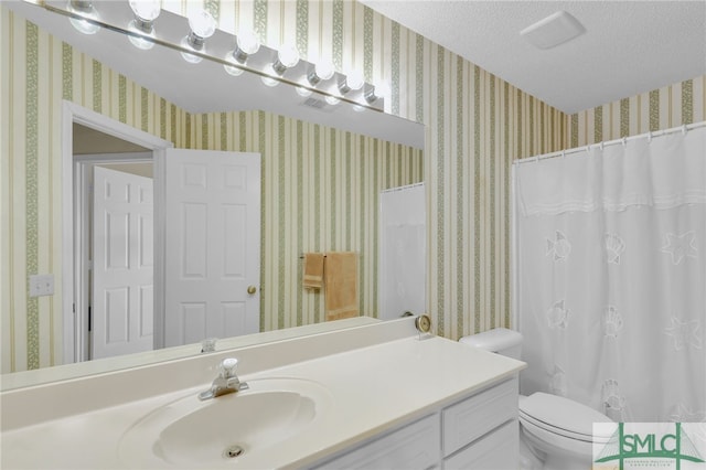 bathroom featuring vanity, toilet, a shower with curtain, and a textured ceiling