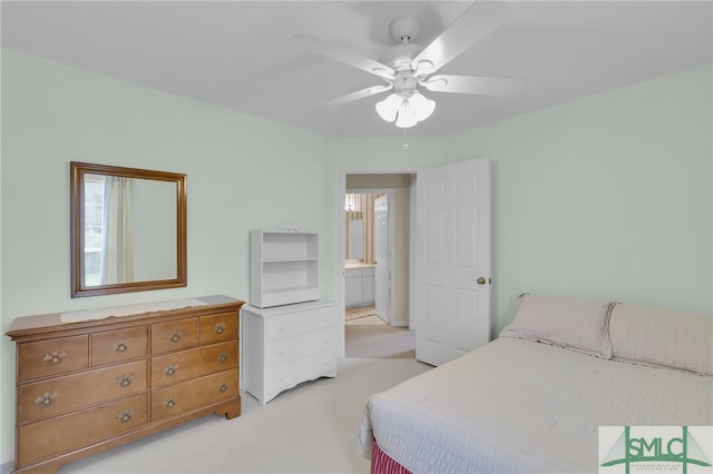 carpeted bedroom with ceiling fan and ensuite bath