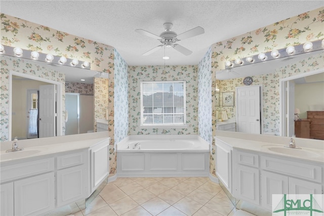 bathroom featuring vanity, a textured ceiling, ceiling fan, and tile patterned floors