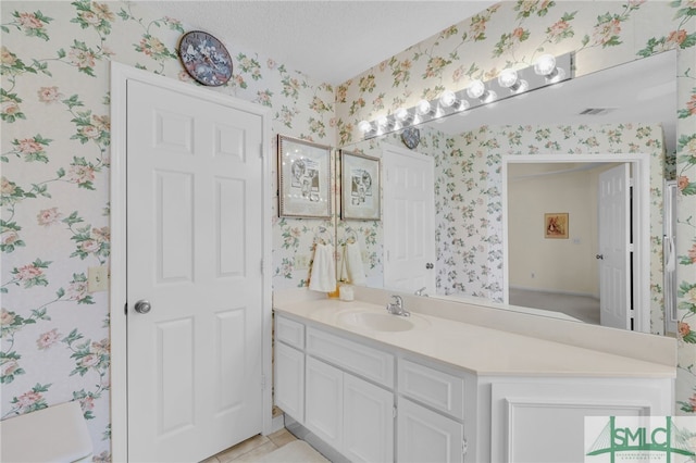 bathroom with tile patterned flooring, toilet, and vanity