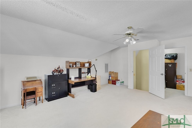 office featuring a textured ceiling, ceiling fan, carpet floors, and vaulted ceiling