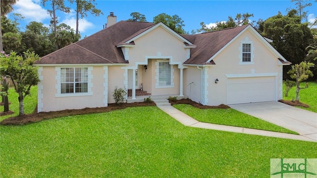 view of front of home featuring a garage and a front yard