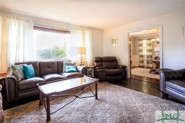 living room featuring an inviting chandelier and wood finished floors