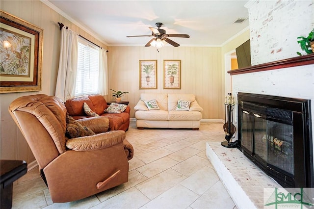 living area with light tile patterned floors, visible vents, a fireplace, ceiling fan, and ornamental molding