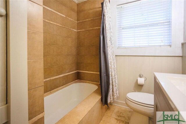 bathroom with tile patterned flooring, shower / bath combination with curtain, toilet, and vanity