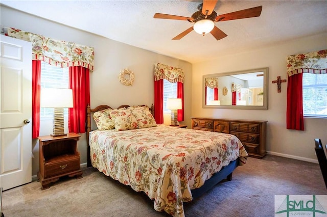 carpeted bedroom featuring ceiling fan and baseboards