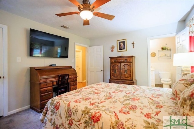 bedroom with a ceiling fan, carpet, visible vents, baseboards, and ensuite bath