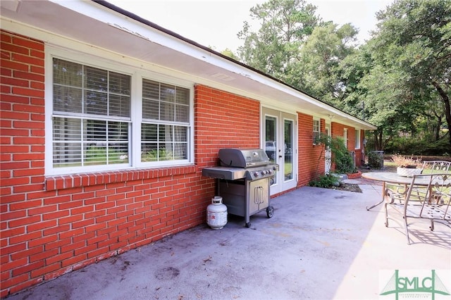 view of patio featuring a grill, french doors, and outdoor dining area