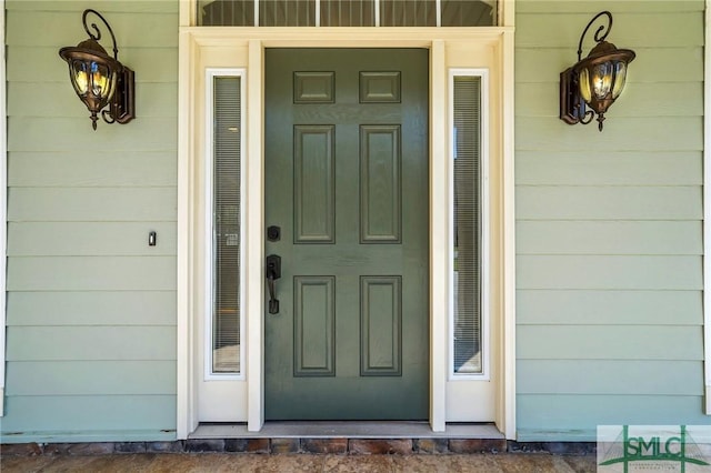 view of exterior entry featuring covered porch