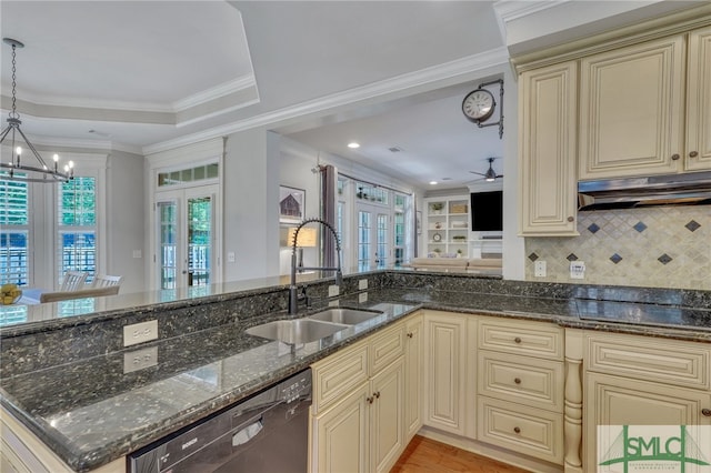 kitchen with dark stone counters, decorative light fixtures, french doors, and ceiling fan with notable chandelier